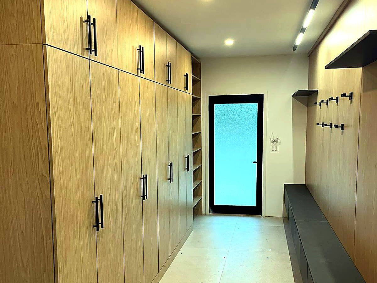 Mudroom with built-in oak storage and bench